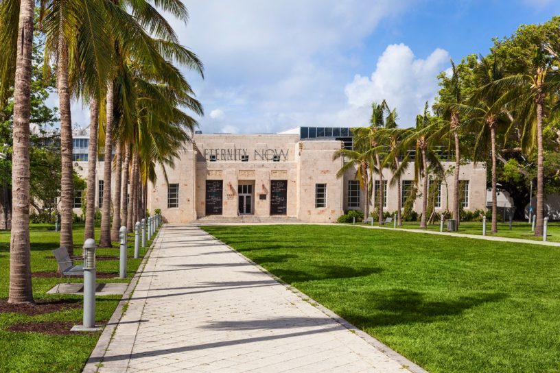 Exterior image of The Bass Museum of Art in Miami, FL with Pathway with Palm Trees