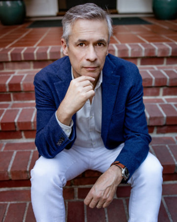 Alexander Nemerov, a white male with dark grey hair, sitting on brick steps