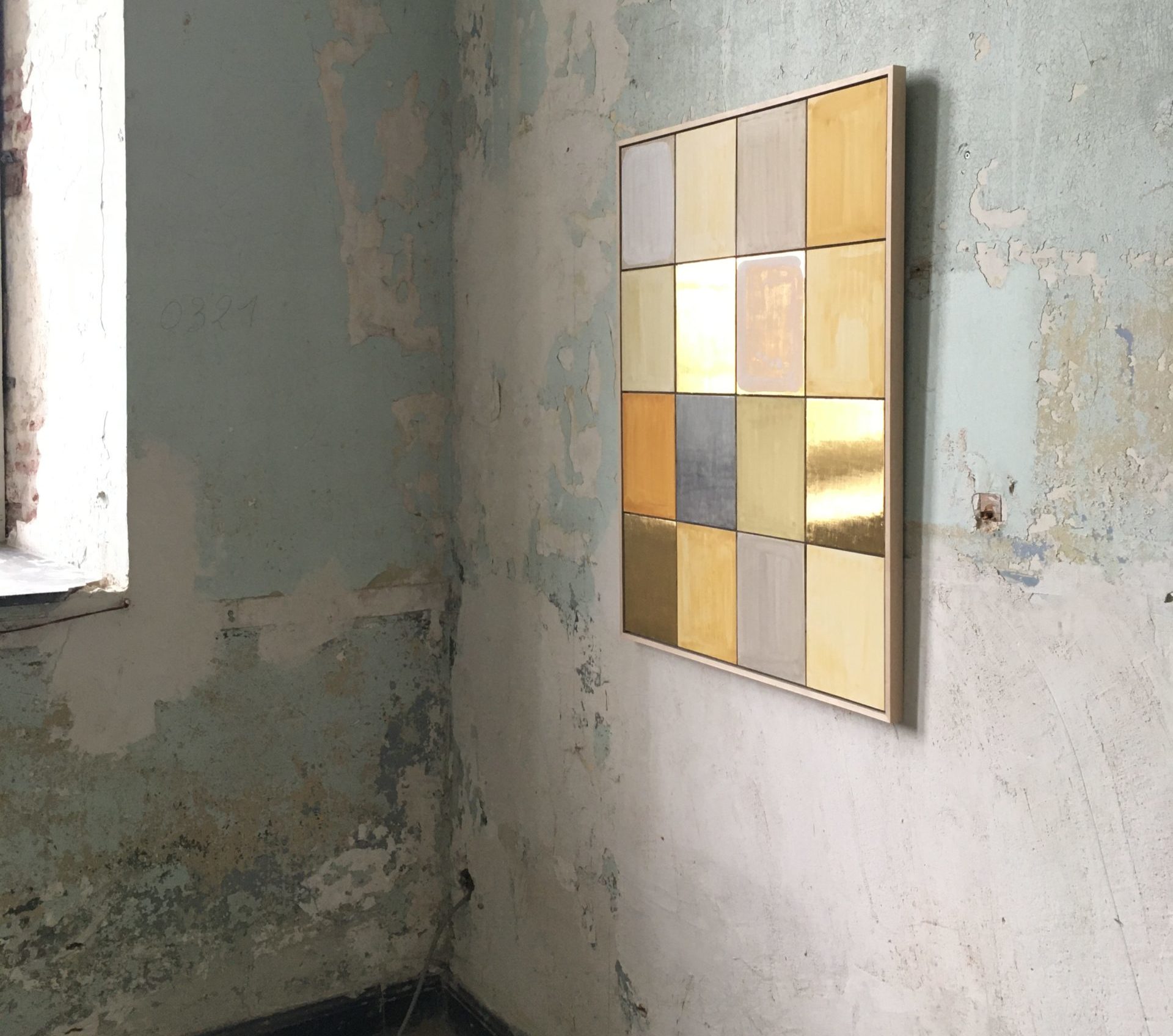 Artwork by Charlotte Caspers hanging on a cement wall