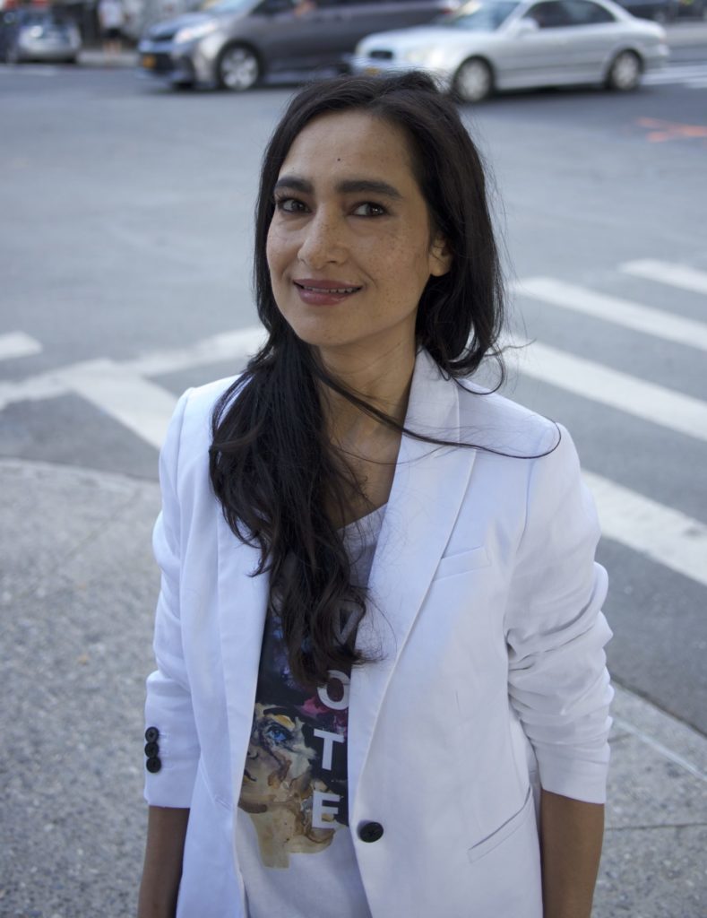 Image of Shahzia Sikander, a Pakistani-American woman with long dark hair, wearing a white blazer