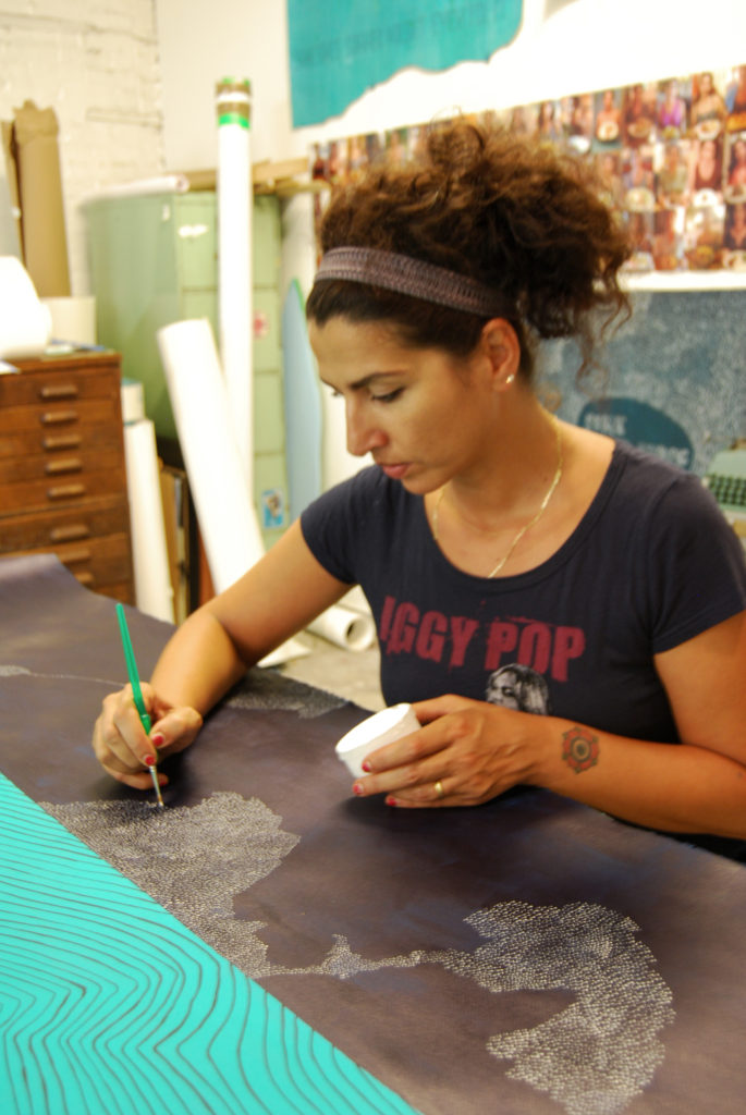 Dahlia Elsayed painting in her studio