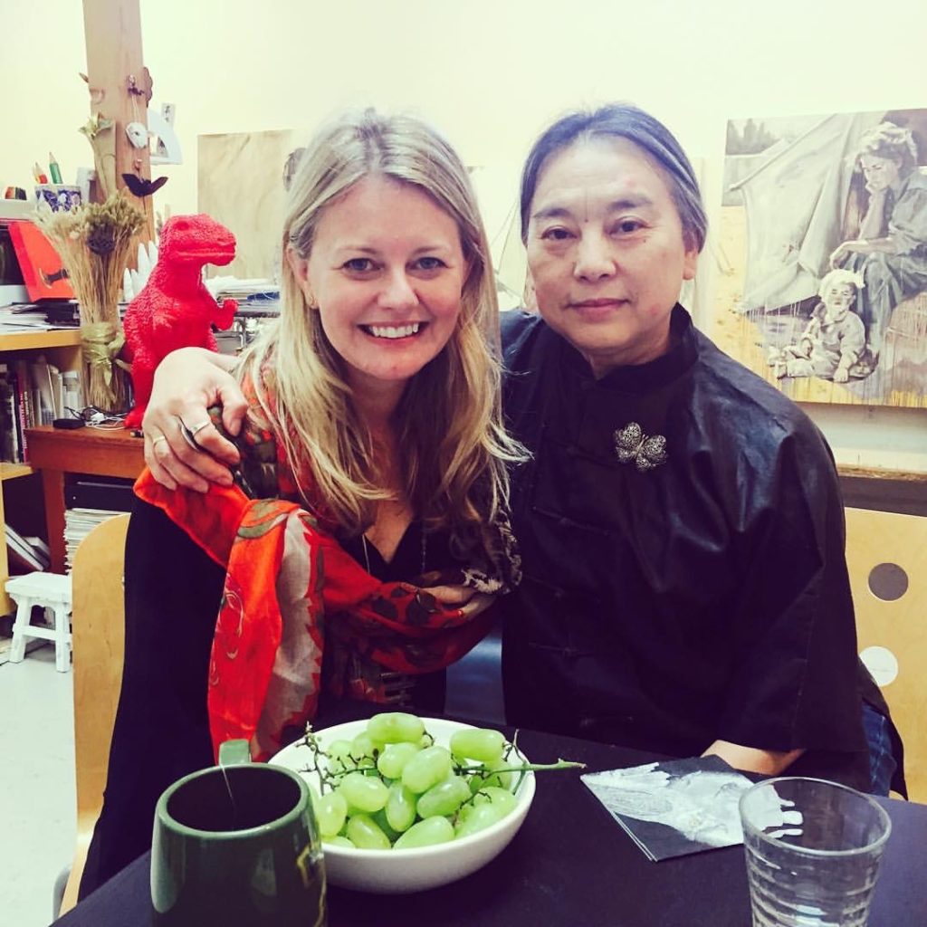 Artist Hung Liu seated with her arm around Dorothy Moss