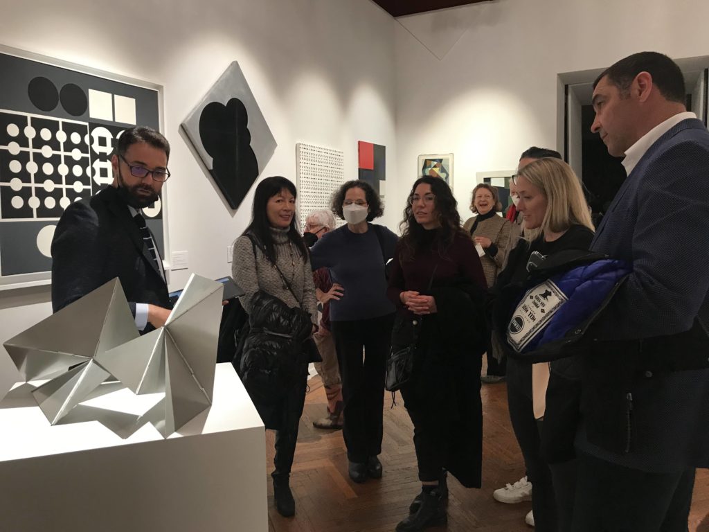 A group observes a sculpture on view at TEFAF New York art fair.