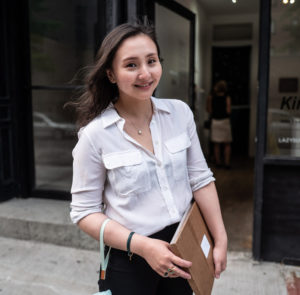 Image of Cecilia standing in front of a storefront
