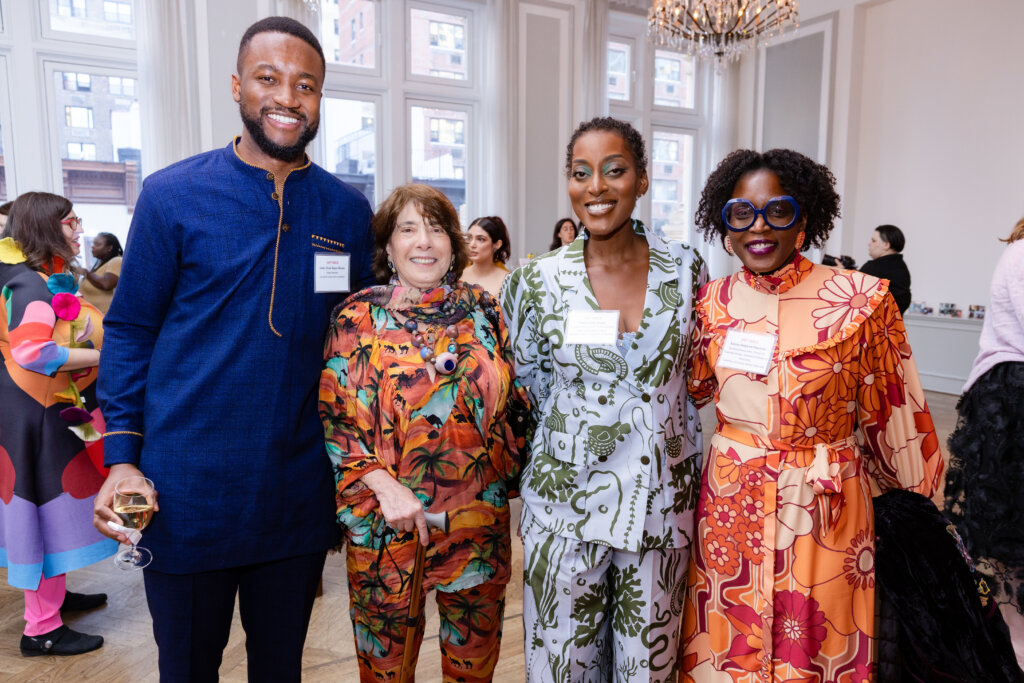 A group of 4 pose for a photo