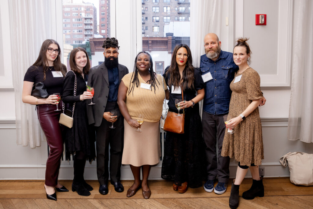 A group of 7 pose for a photo
