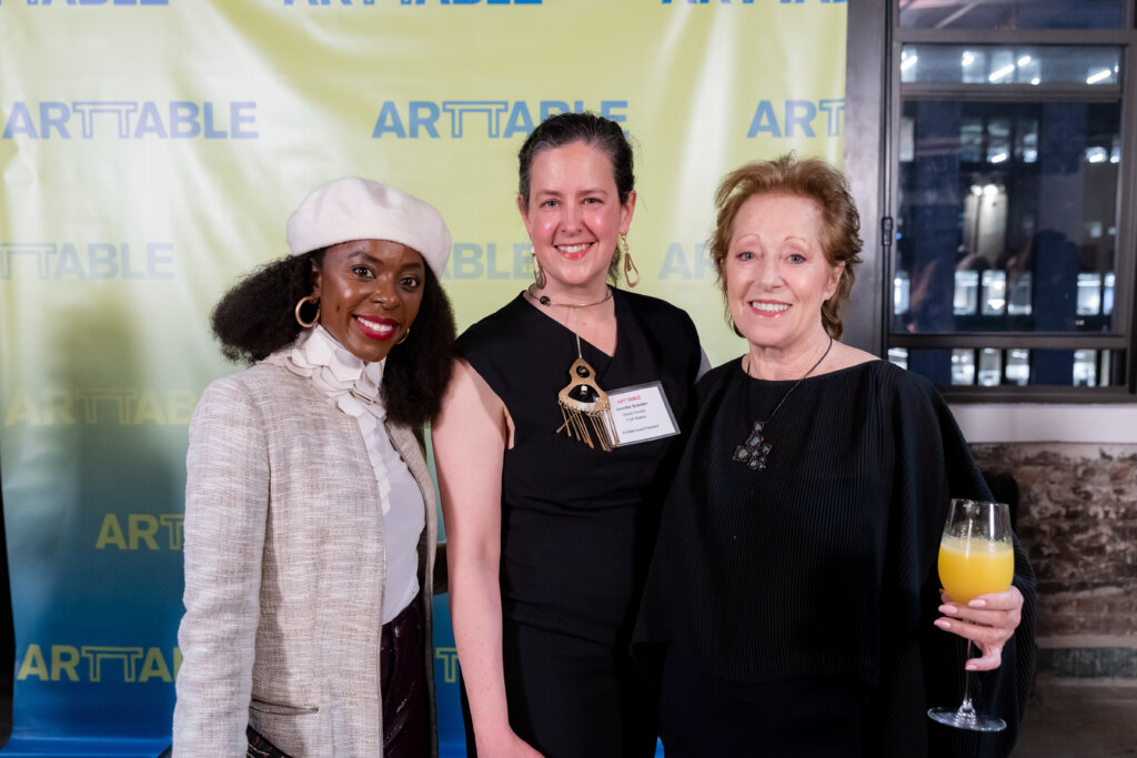 Three women smiling.