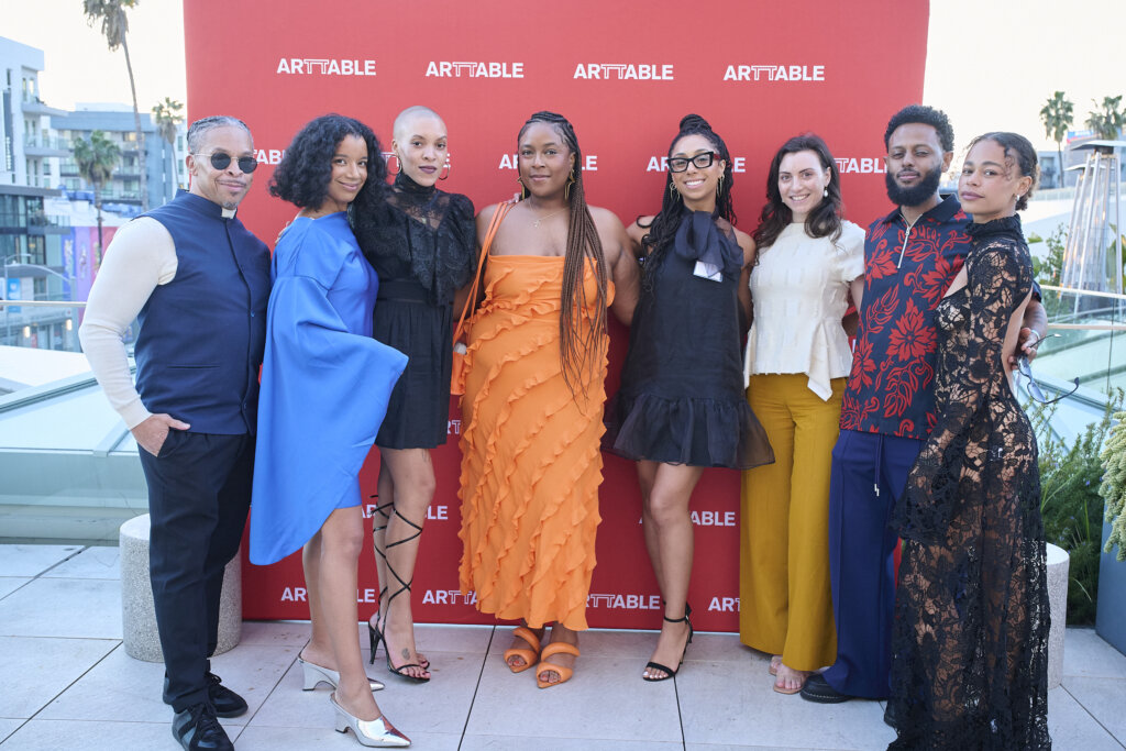 Eight guests in front of the ArtTable banner.