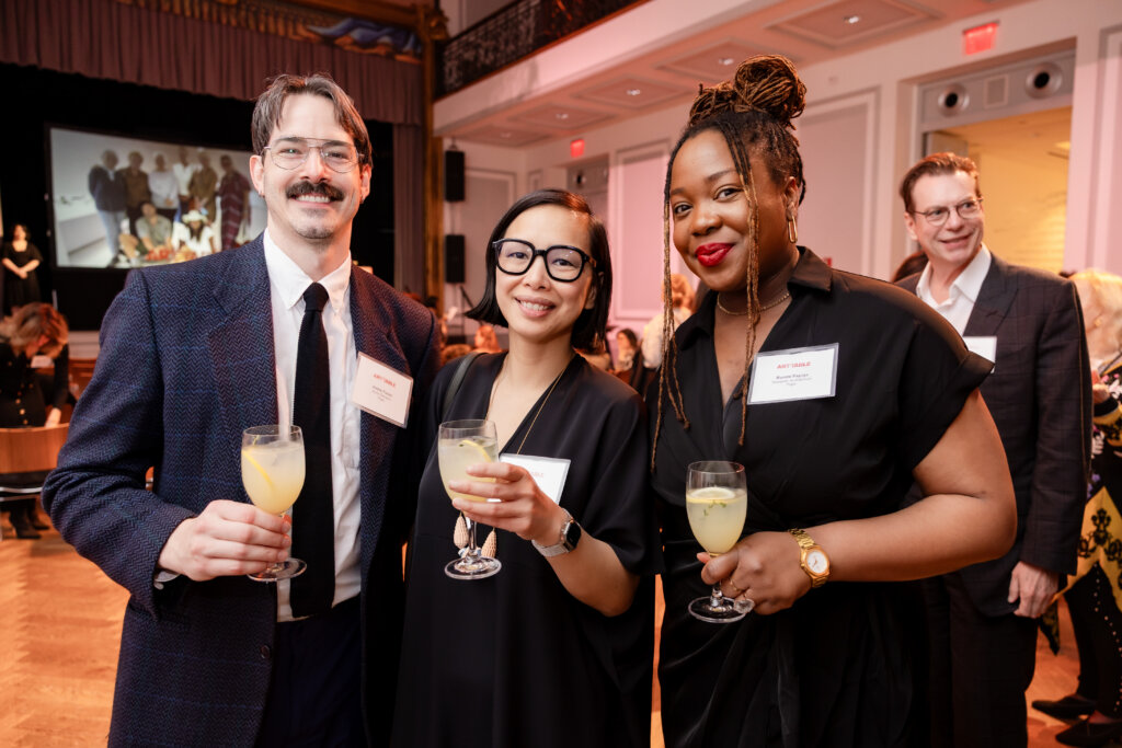 Three people pose for a photo