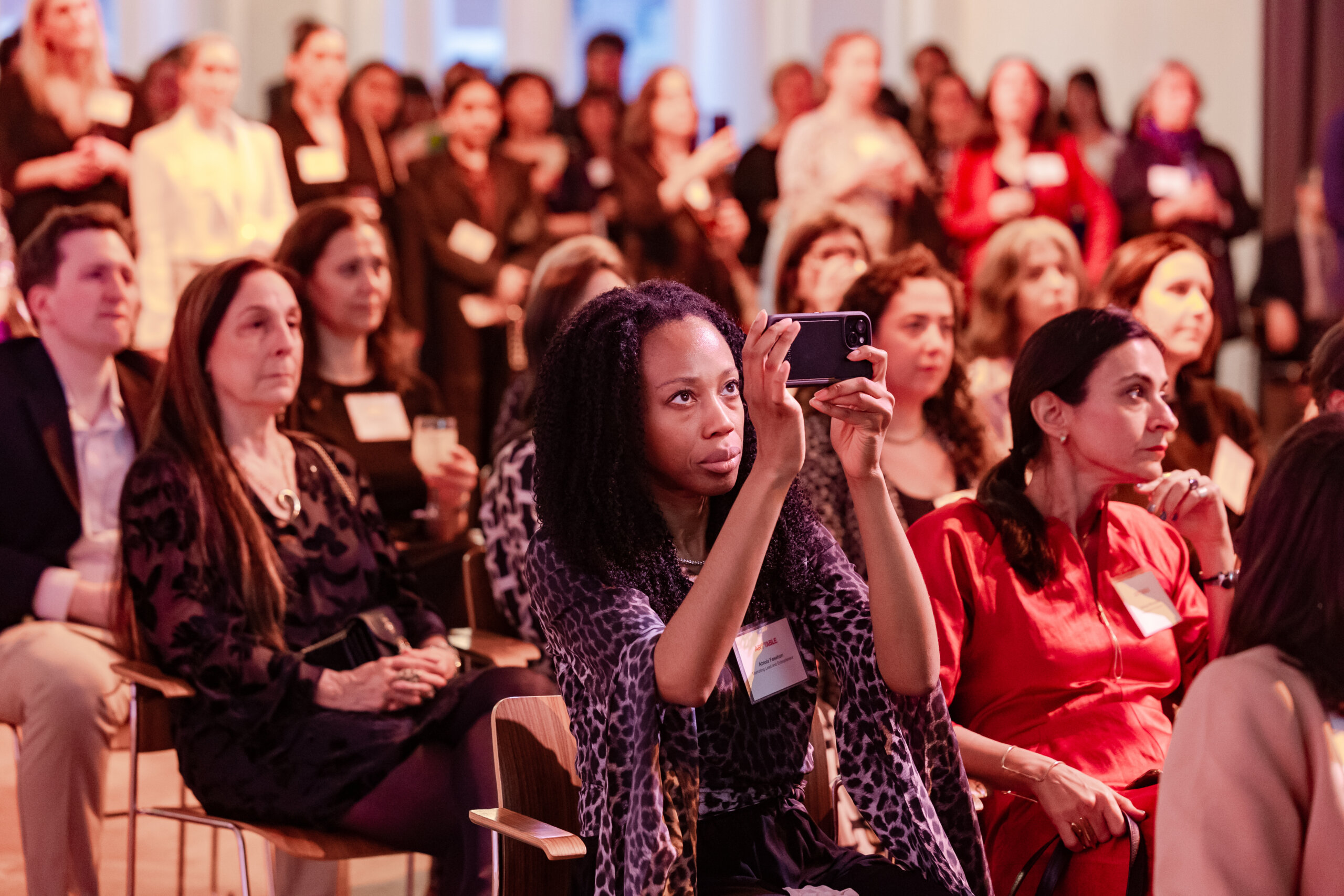 A crowd is seated in an auditorium