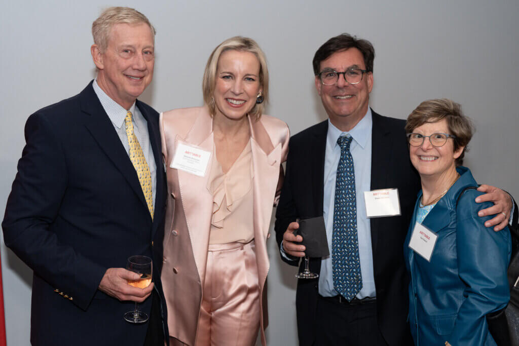 4 individuals smiling at the camera