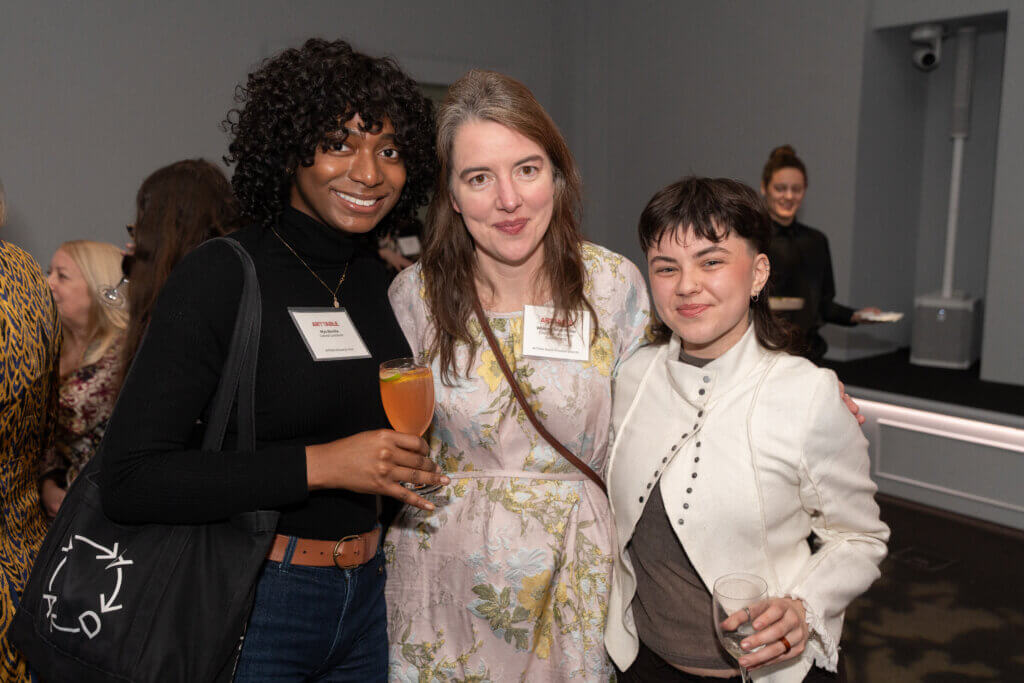 3 individuals smiling at the camera
